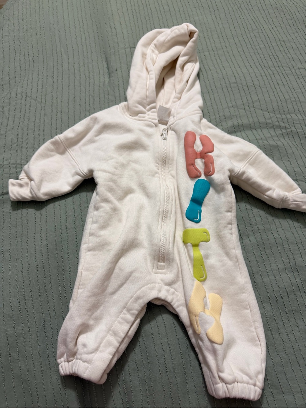 Kith Cream Hooded Baby One-Piece with Multicolor Letter Accents